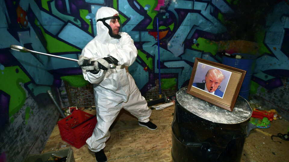 Paul Lietz of Bristol smashes a framed photograph of President Donald Trump at the Explicitly Broken Rage Rooms in Derby during Trump’s inauguration on January 20, 2025. The Inauguration Day Rage Room event organized by Prism Counseling and Support was advertised to allow people to “vent in a healthy and safe way.”