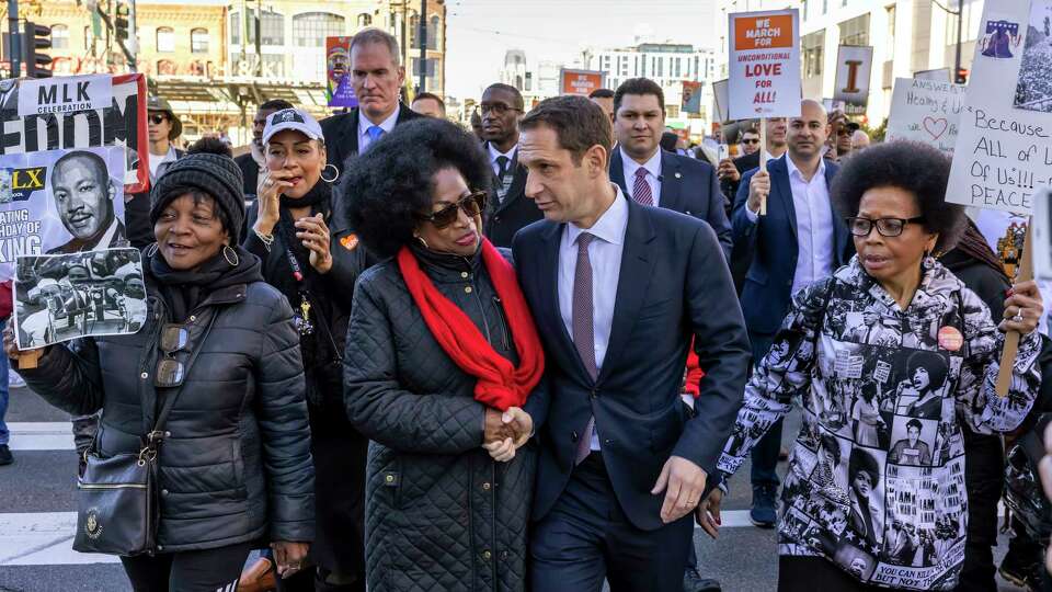 San Francisco Mayor Daniel Lurie chats with Dr. Carolyn Ransom-Scott during a march to honor Dr. Martin Luther King on his birthday in San Francisco, on Monday, January 20, 2025.