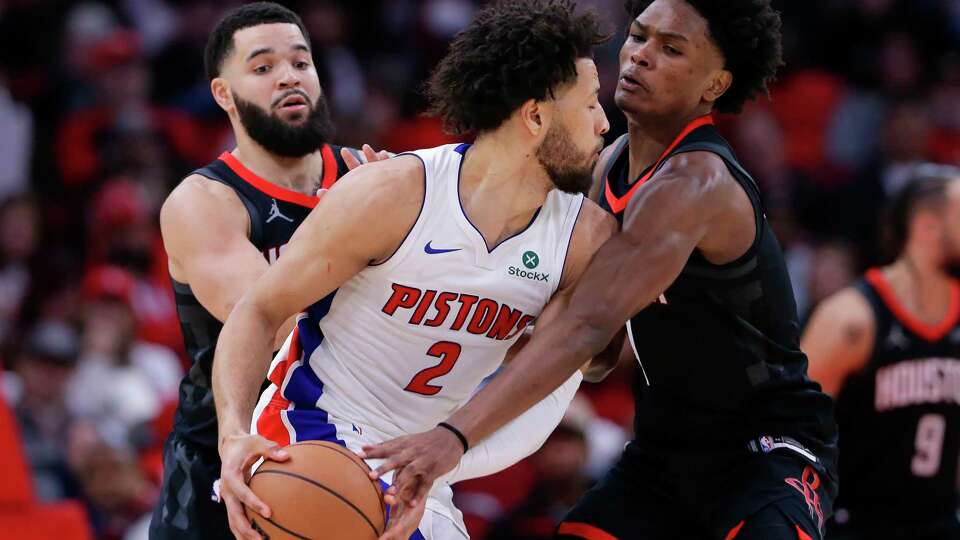 Detroit Pistons guard Cade Cunningham (2) is double-teamed by Houston Rockets guard Fred VanVleet, left, and forward Amen Thompson, right, during the second half of an NBA basketball game Monday, Jan. 20, 2025, in Houston. (AP Photo/Michael Wyke)