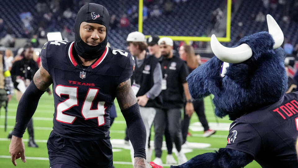 Houston Texans cornerback Derek Stingley Jr. runs past Toro as he leaves the field after the Texans 32-12 win over the Los Angeles Chargers in an AFC Wild Card playoff football game, Saturday, Jan. 11, 2025, in Houston.