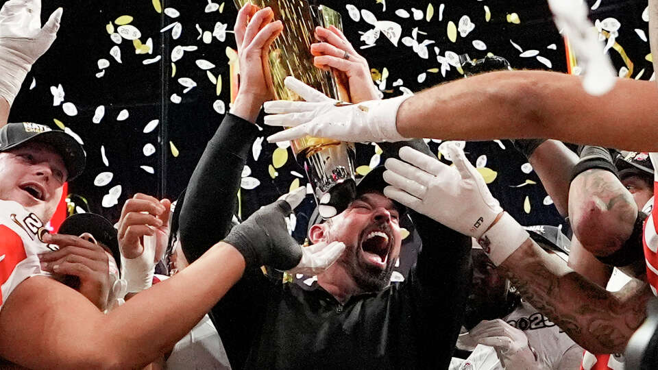 Ohio State head coach Ryan Day celebrates with the trophy after their win against Notre Dame in the College Football Playoff national championship game Monday, Jan. 20, 2025, in Atlanta. (AP Photo/Brynn Anderson)