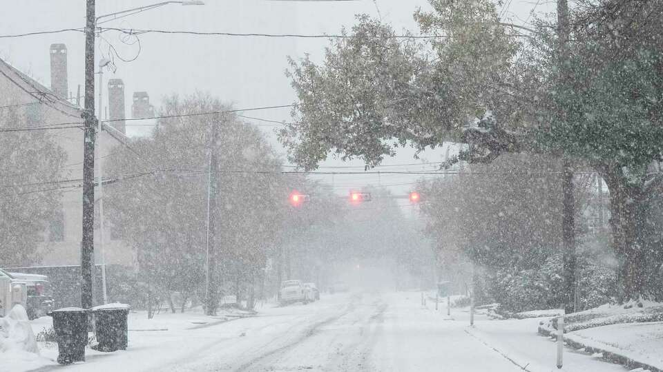 Waugh Drive is quiet and calm as snow is falling during Winter Storm Enzo Tuesday, Jan. 21, 2025 in Houston.