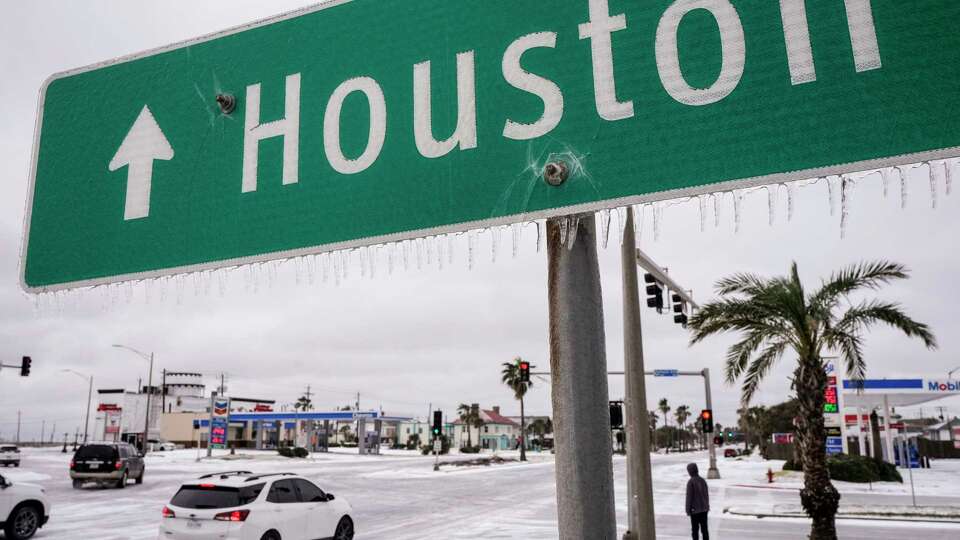 Icicles hang from a sign pointing the way to Houston during an icy winter storm on Tuesday, Jan. 21, 2025 in Galveston.