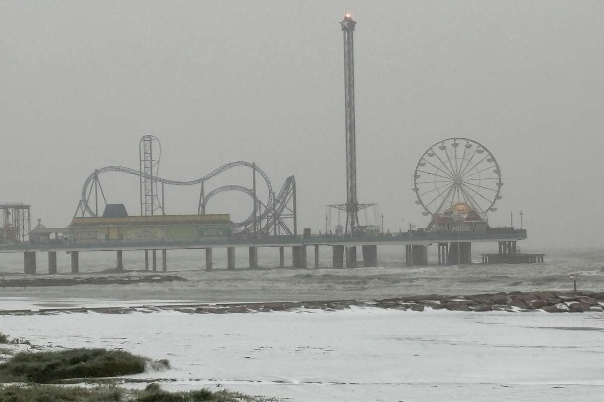 The beach beside Pleasure Pier was blanketed with a fine dusting of snow Tuesday morning.