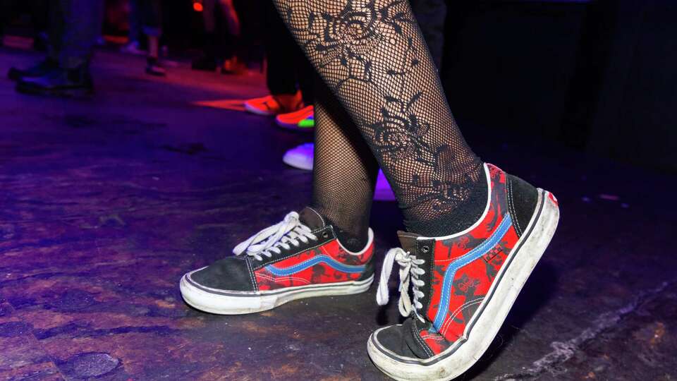 Emilio Valencia, 26, styles a pair of Vans sneakers with fishnets at the Cat Club during the “Riot! At The Disco” party on Friday, Oct. 4, 2024.