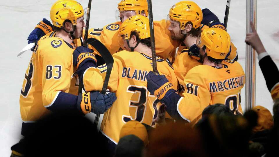 Nashville Predators defenseman Nick Blankenburg (37) is congratulated after scoring the winning goal against the San Jose Sharks during the third period of an NHL hockey game Tuesday, Jan. 21, 2025, in Nashville, Tenn.