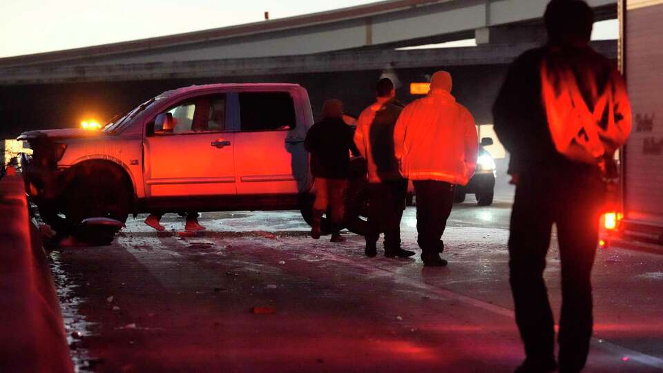 Harris County Emergency Services District No. 20 Firefighters with Station 43 work at the scene of a single vehicle crash on the SH249 overpass of the North Sam Houston Parkway Wednesday, Jan. 22, 2025, in Houston.