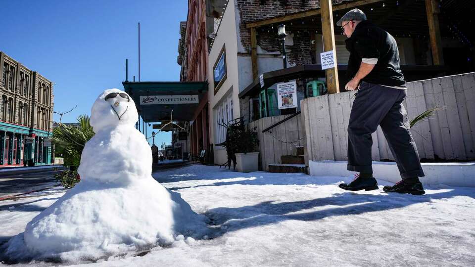 A snowman still stands as snow and ice begin to melt in The Strand as businesses on the island reopened in the aftermath of an icy winter storm on Wednesday, Jan. 22, 2025 in Galveston.