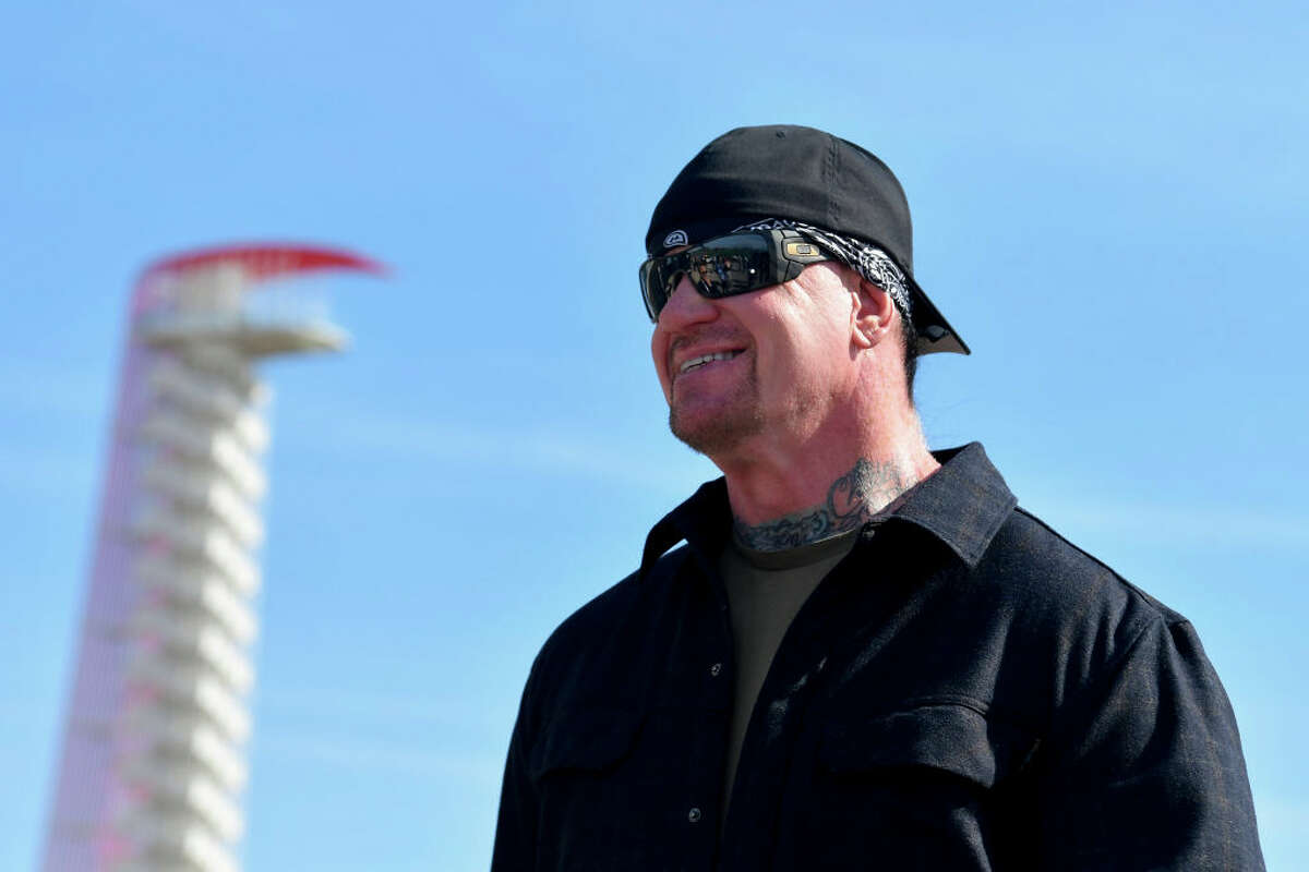 Professional wrestler The Undertaker posse for a photo prior to his pace car practice ride for the NASCAR Cup Series Echopark Automotive Grand Prix at Circuit of The Americas.