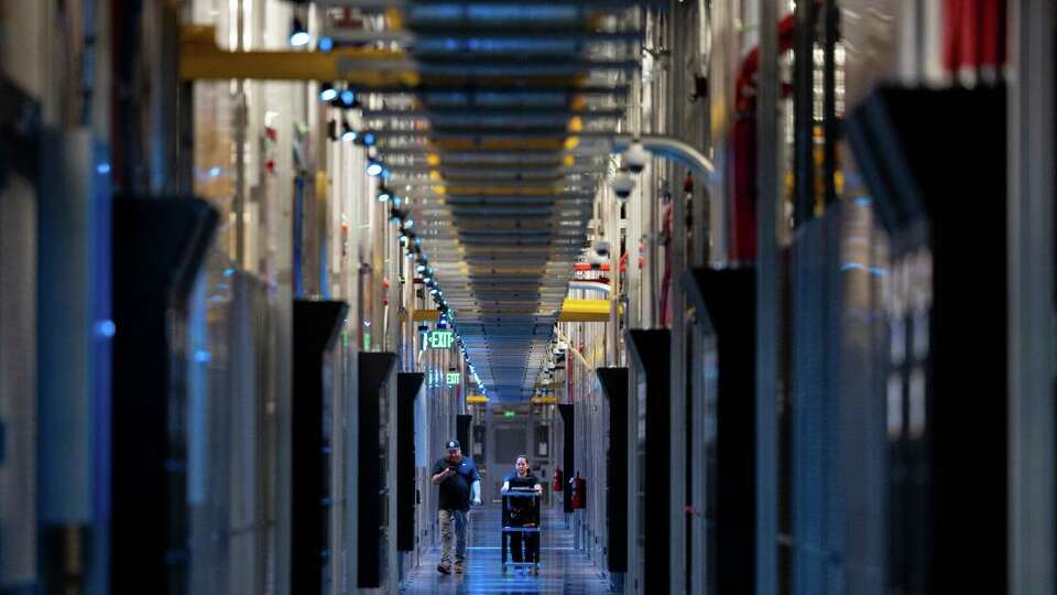 ASHBURN, VA - MAY 9: People walk through the hallways at Equinix Data Center in Ashburn, Virginia, on May 9, 2024. (Amanda Andrade-Rhoades for The Washington Post via Getty Images)