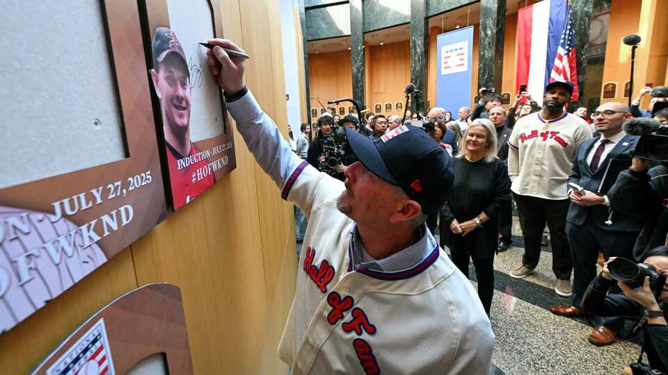 Newly-elected Baseball Hall of Fame member Billy Wagner signs the backer board where his plaque will hang during a news conference Thursday, Jan. 23, 2025, in Cooperstown, N.Y. (AP Photo/Hans Pennink)