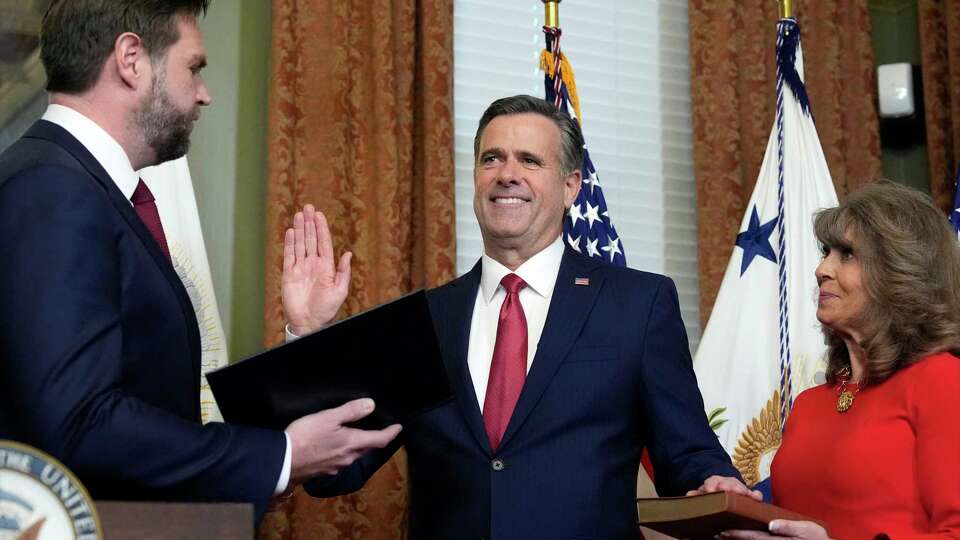 Vice President JD Vance swears in John Ratcliffe as CIA Director as his wife Michele holds the Bible in the Vice Presidential ceremonial office in the Eisenhower Executive Office Building on the White House campus, Thursday, Jan. 23, 2025, in Washington.