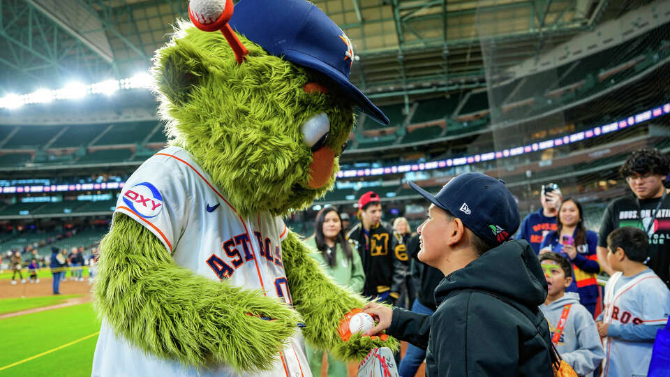 Fans spend time with Orbit, the mascot of the Houston Astros during Astros FanFest on Saturday, Jan. 20, 2024.