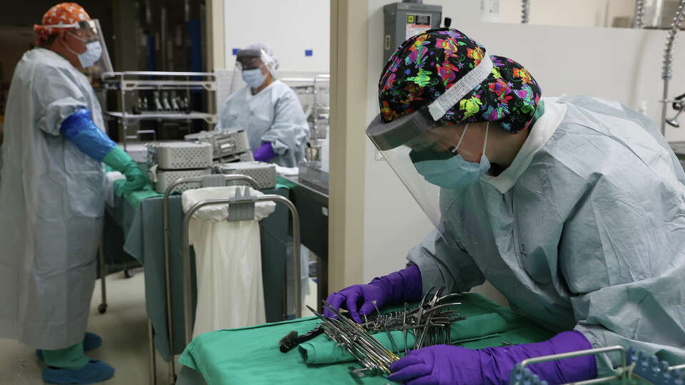 Workers prepare medical tool for sterilization in July 2023 at Brook Army Medical Center’s Sterile Processing Division.