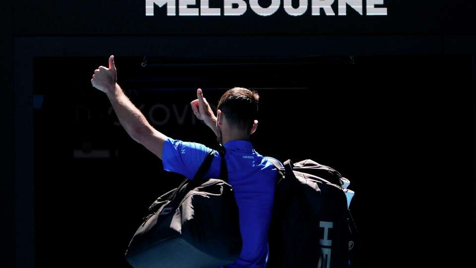 Novak Djokovic of Serbia gestures as he leaves Rod Laver Arena after retiring in his semifinal match against against Alexander Zverev of Germany at the Australian Open tennis championship in Melbourne, Australia, Friday, Jan. 24, 2025.