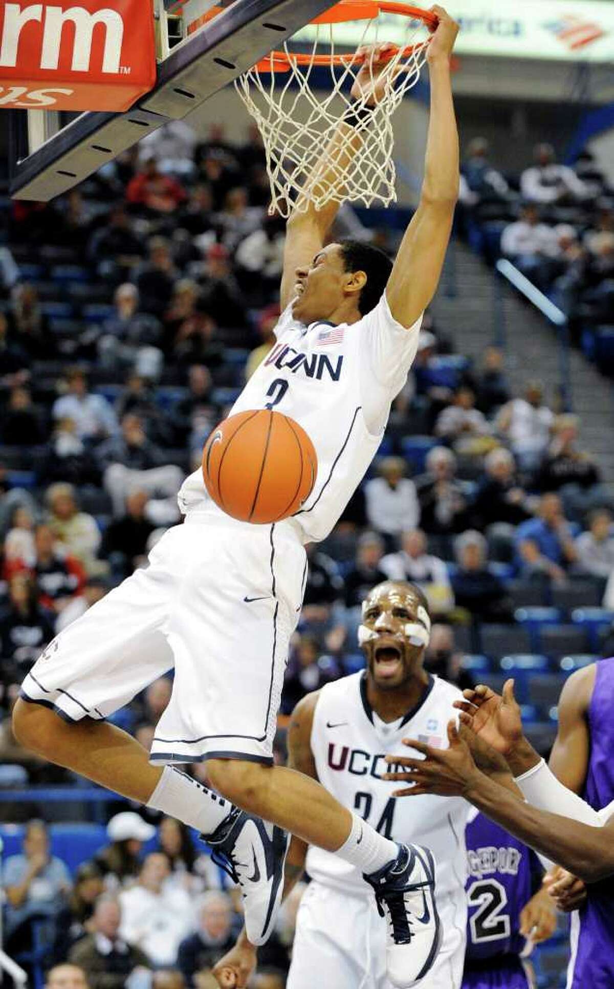 Connecticut's Jeremy Lamb, left, scores as teammate Alex Oriakhi looks on during the second half of Connecticut's 103-57 victory over Bridgeport in an exhibition NCAA college basketball game in Hartford, Conn., on Sunday, Nov. 7, 2010. Lamb, a freshman, scored 17 points and had eight rebounds. (AP Photo/Fred Beckham)