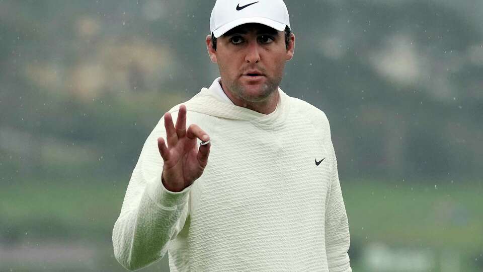 FILE - Scottie Scheffler gestures on the 18th green at Pebble Beach Golf Links during the third round of the AT&T Pebble Beach National Pro-Am golf tournament in Pebble Beach, Calif., Saturday, Feb. 3, 2024. (AP Photo/Ryan Sun, File)