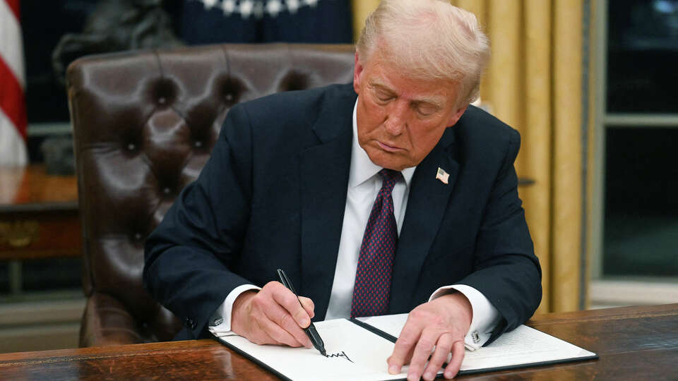 US President Donald Trump signs an executive order in the Oval Office of the White House in Washington, DC, on Jan. 20, 2025.