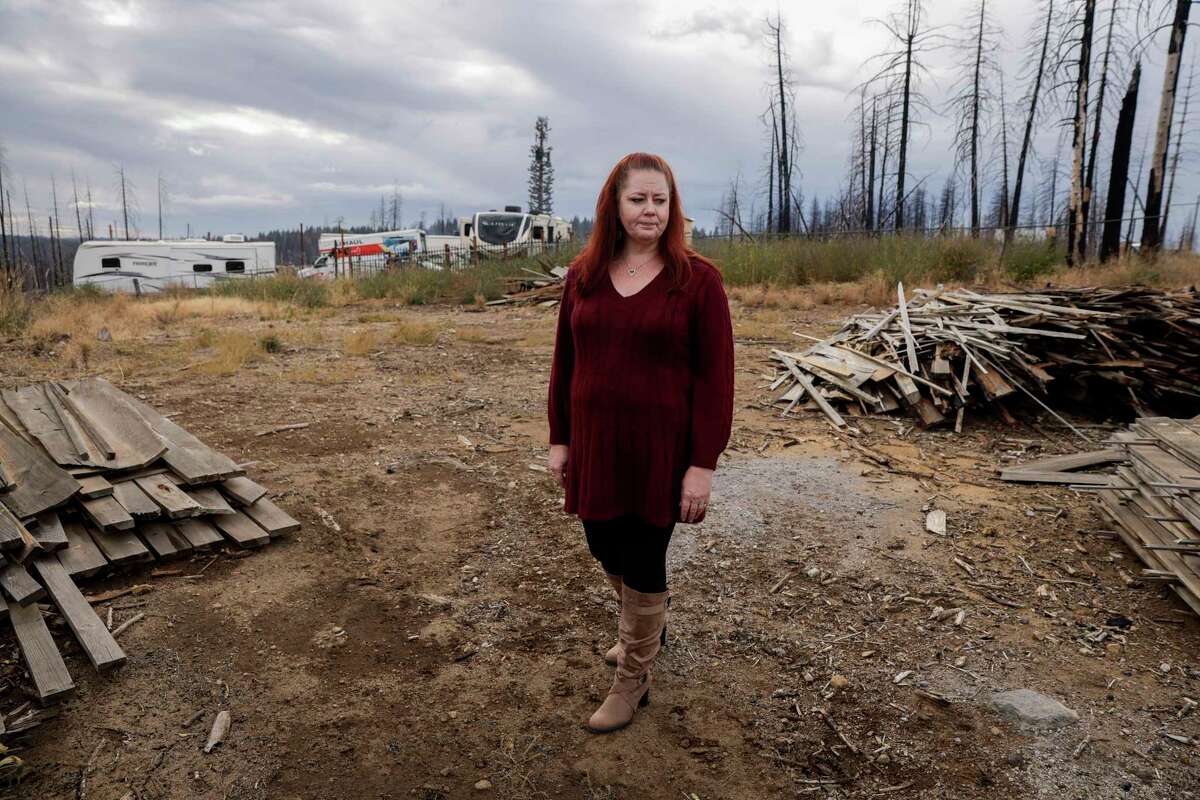 Jennifer McKim-Hibbard stands on her empty lot in Grizzly Flats (El Dorado County) in November. A Caldor Fire survivor whose home burned down in 2021, McKim-Hibbard, then a FAIR Plan policyholder, said it took over a year to receive her payout.