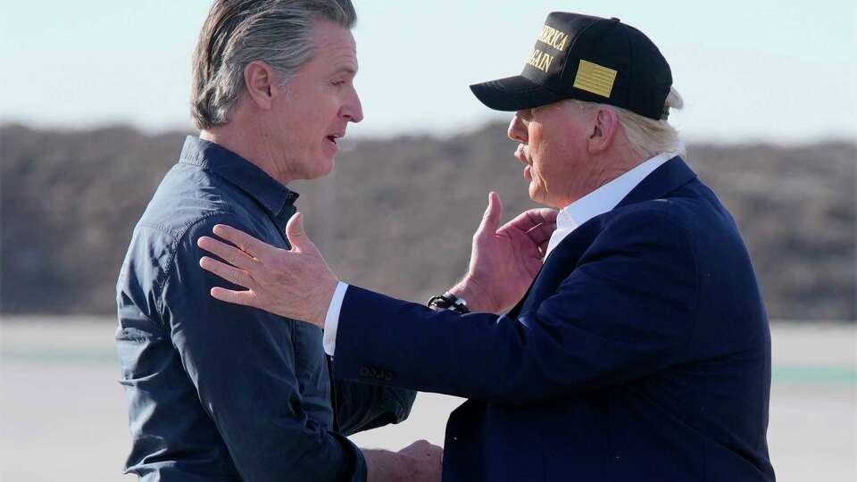 President Donald Trump talks with California Gov. Gavin Newsom after arriving on Air Force One at Los Angeles International Airport in Los Angeles, Friday, Jan. 24, 2025. (AP Photo/Mark Schiefelbein)