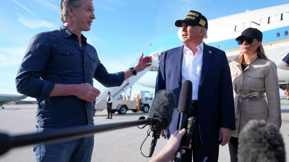 President Donald Trump and first lady Melania Trump listen to California Gov. Gavin Newsom after arriving on Air Force One at Los Angeles International Airport in Los Angeles, Friday, Jan. 24, 2025. (AP Photo/Mark Schiefelbein)