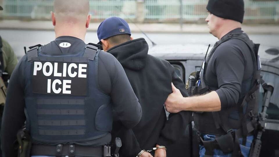 This image obtained February 11, 2017 courtesy of the Immigration and Customs Enforcement (ICE) shows US Immigration and Customs Enforcement officers detaining a suspect during an enforcement operation on February 7, 2017 in Los Angeles, California. US authorities arrested hundreds of undocumented migrants this week in the first large-scale raids under President Donald Trump, triggering panic in immigrant communities nationwide. The federal Immigration and Customs Enforcement agency rounded up undocumented individuals living in Atlanta, Austin, Chicago, Los Angeles, New York and other cities two weeks after Trump signed an executive order that broadened which undocumented immigrants would be targeted for deportation. According to ICE, however, the operations were 'routine.' / AFP PHOTO / ICE / Charles ReedCHARLES REED/AFP/Getty Images