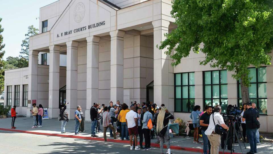 Community members and media gather during a rally held outside A.F. Bray Courthouse in Martinez, Calif. Friday, Aug. 25, 2023 following a hearing related to a 2021 fatal shooting charge that is threatening to unravel due to an ongoing corruption probe at the Antioch Police Department. Judge David E. Goldstein had already determined in May that there was proof of racial bias in the charging decisions of the county District Attorney’s Office, which charged four men with murder and attempted murder related to a March 2021 drive-by shooting that prosecutors alleged was gang related. But two of the defendants, Trent Allen and Terryon Pugh, were among a number of people named in racist text messages released in April as part of a wide-ranging corruption investigation into the Antioch and Pittsburg police departments by the same D.A.’s Office and the FBI.