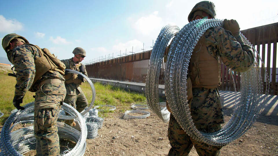 U.S. Marines deployed to the U.S. Mexico border in San Diego work to fortify the border wall with concertina wire at the Otay Mesa Port of entry in May 2023.