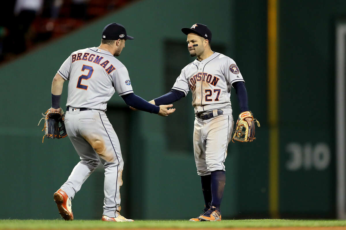 Alex Bregman and Jose Altuve of the Houston Astros celebrate their team's win over the Boston Red Sox in Game One of the American League Championship Series at Fenway Park on October 13, 2018 in Boston, Massachusetts.