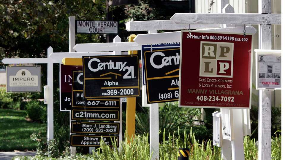 Signs for several existing homes for sale are seen in San Jose, Calif., in this, Sept. 4, 2007 file photo. The National Association of Realtors reports how many people signed contracts to buy existing homes in April later Thursday May 29, 2014. (AP Photo/Paul Sakuma, File)