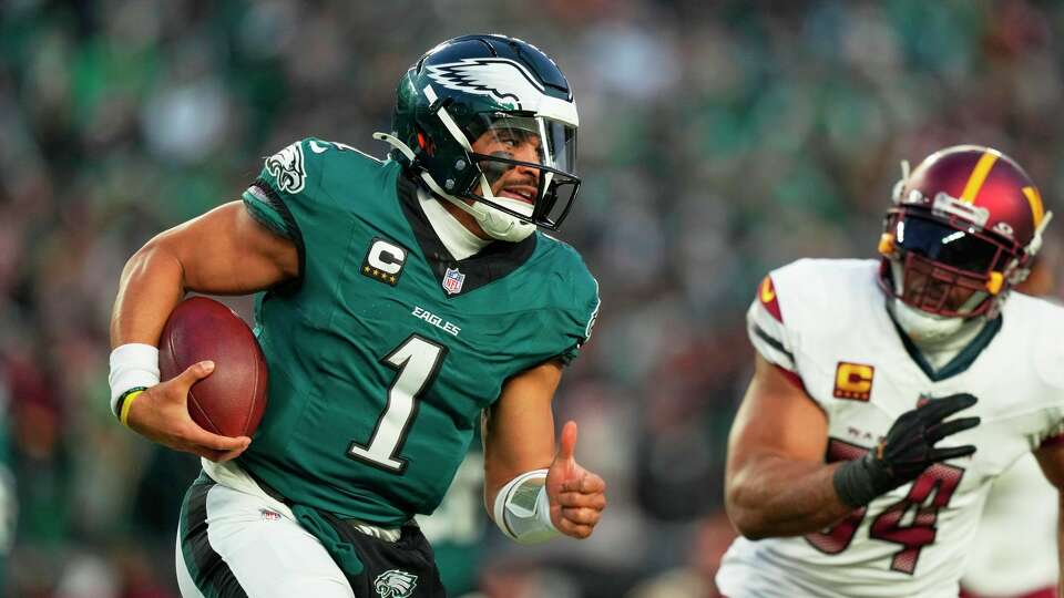 Philadelphia Eagles quarterback Jalen Hurts (1) rushes for a gain as Washington Commanders linebacker Bobby Wagner (54) defends during the second half of the NFC Championship NFL football game, Sunday, Jan. 26, 2025, in Philadelphia.