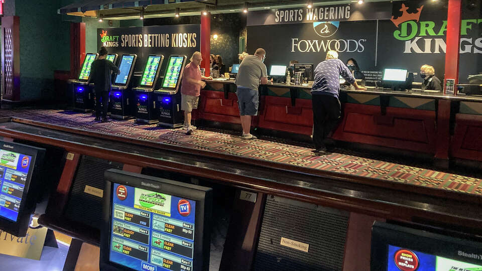 Gamblers place their bets on sports for the first time at Foxwoods Resort Casino in Mashantucket, Conn., Thursday Sept. 30, 2021.