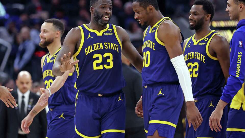 Golden State Warriors’ Draymond Green, Jonathan Kuminga, Andrew Wiggins and Stephen Curry after Kuminga’s buzzer-beater in 3rd quarter of Dubs’ 128-110 win over Los Angeles Lakers during NBA game at Chase Center in San Francisco on Thursday, February 22, 2024.