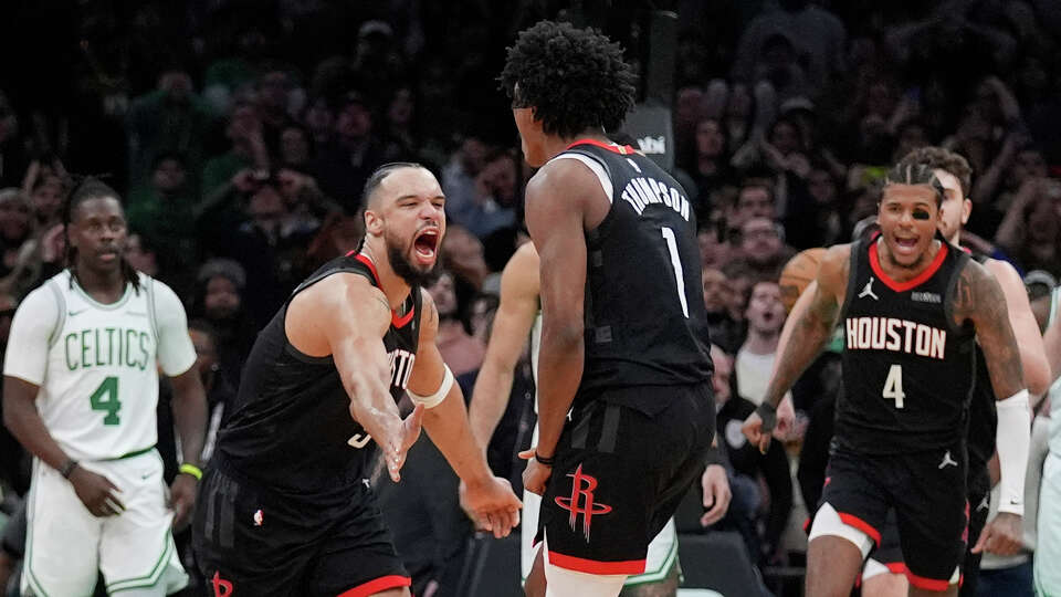 Houston Rockets forward Amen Thompson (1) is congratulated by Dillon Brooks, front left, after making the winning basket against the Boston Celtics in the final seconds of an NBA basketball game, Monday, Jan. 27, 2025, in Boston. (AP Photo/Charles Krupa)