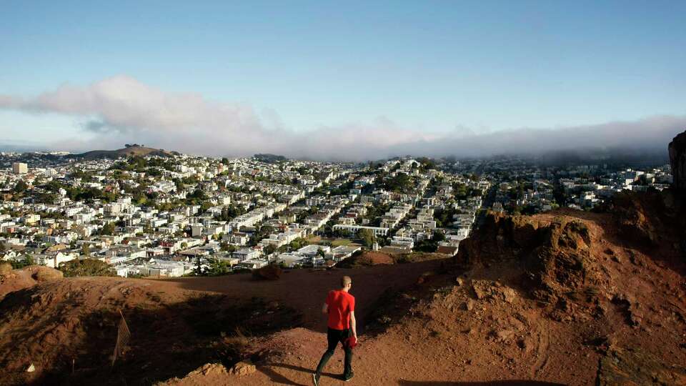 A visitor traverses the top of Corona Heights on August 15, 2013 in San Francisco, Calif.