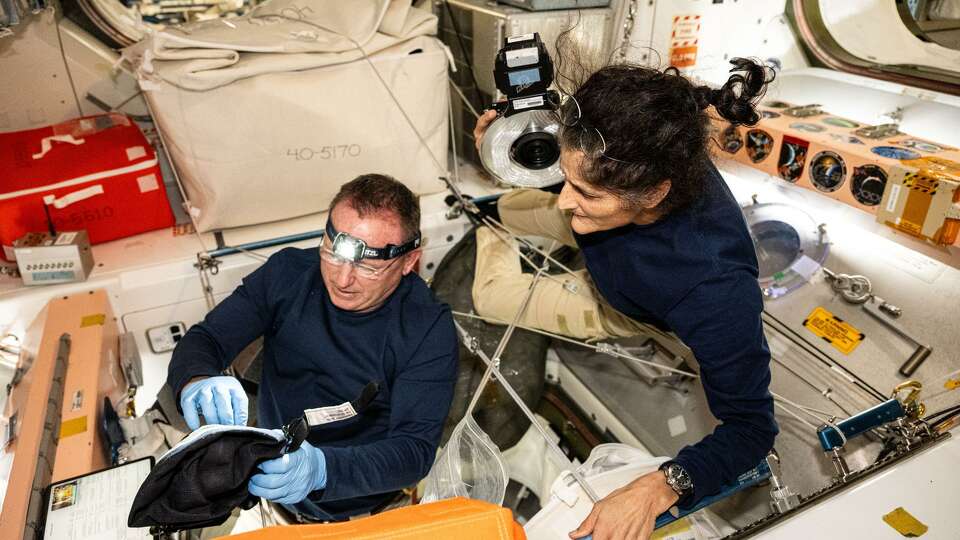 NASA astronauts Butch Wilmore and Suni Williams, Boeing's Crew Flight Test Commander and Pilot respectively, inspect safety hardware aboard the International Space Station on Aug. 9, 2024. President Donald Trump and SpaceX founder Elon Musk are vowing to bring the astronauts home as they've been in space nearly eight months.