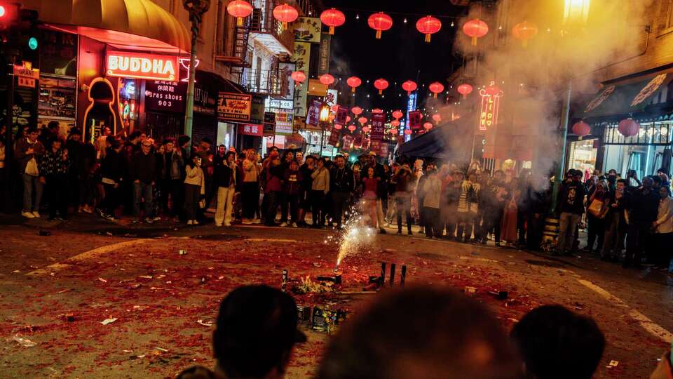 Spectators gather for fireworks in Chinatown after the 2024 Alaska Airlines Chinese New Year Parade in San Francisco, Saturday, Feb. 24, 2024.