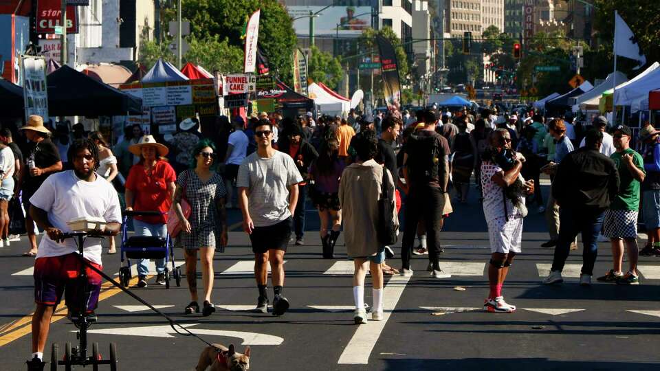 People along Telegraph Avenue during First Fridays in Oakland, Calif., on Friday, July 05, 2024.