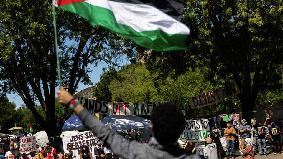 Palestinian demonstrator Mohammad Elsheik waves a Palestinian flag during a rally the student encampment in White Plaza in Stanford on May 12, 2024.