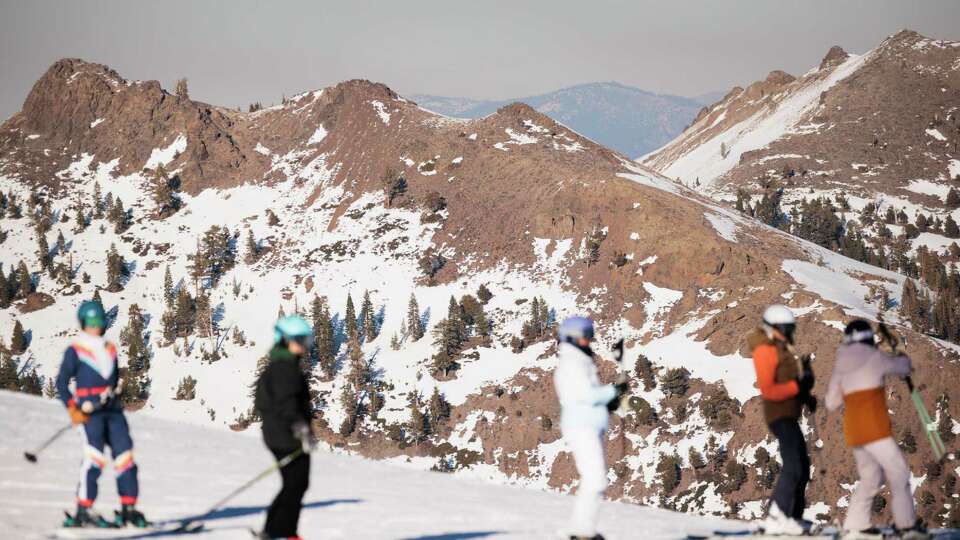 While most runs at Palisades Tahoe have adequate snow coverage, nearby south-facing slopes are dry in Olympic Valley, Wednesday, January 29, 2025. Despite a dry January, most of Palisades Tahoe has snow covered runs.