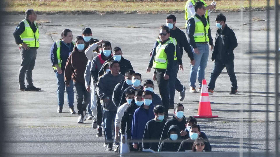 Guatemalan migrants deported from the United States disembark a U.S. military plane at La Aurora Airport in Guatemala City, Monday, Jan. 27, 2025.