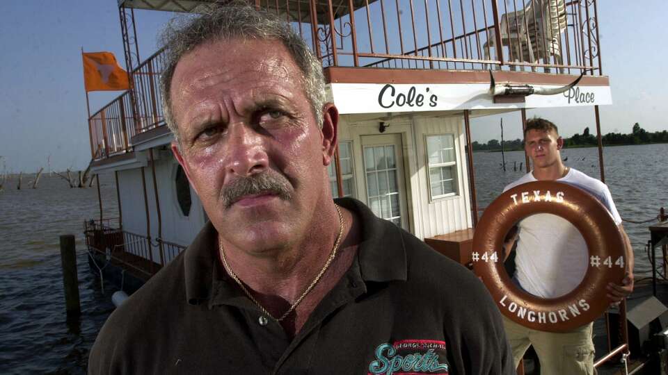 Marc Pittman, left, and his son Chase Pittman, who will be a senior at Evangel Christian Academy, pose Wednesday, June 13, 2001, in Shreveport, La., for a portrait on their houseboat named Cole's Place, in memory of Pittman's son Cole Pittman, who was killed in an automoblie accident in February 2001, while returning to the University of Texas. Pittman was a member of the football team. Nearly four months after his son was buried in the red Louisiana dirt, Marc Pittman still can't recall much of what he uttered at the lectern at the First Assembly of God sanctuary that rainy Wednesday last February. But the muscular 6-foot-6, 250-pounder's eyes moisten when he repeats the main message of his eulogy: 'I'm a construction worker. I'm a tough guy. I can fight and scrap with the best of them. But my children changed my life. God changed my life.'