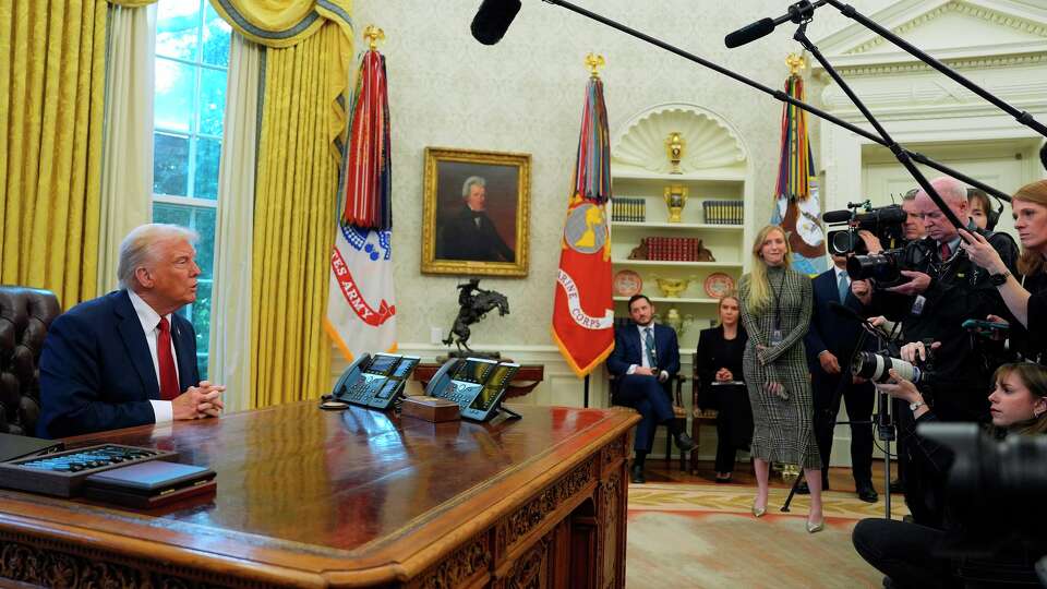 President Donald Trump talks with reporters as he signs executive orders in the Oval Office at the White House, Thursday, Jan. 30, 2025, in Washington.