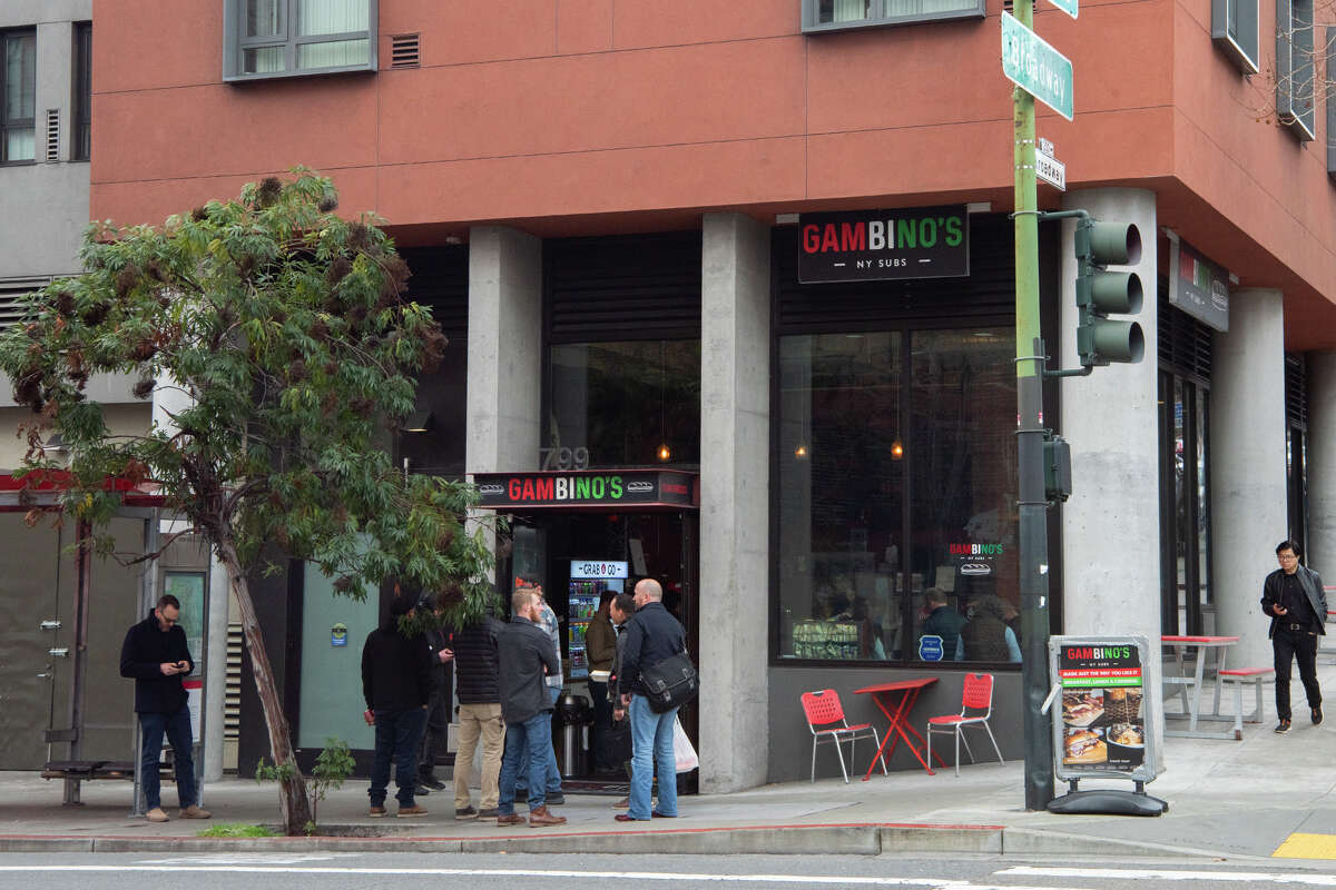 Customers mingle with their orders outside of the Gambino's location on Battery Street in downtown San Francisco during the lunch rush on Wednesday, Jan. 30, 2025. 