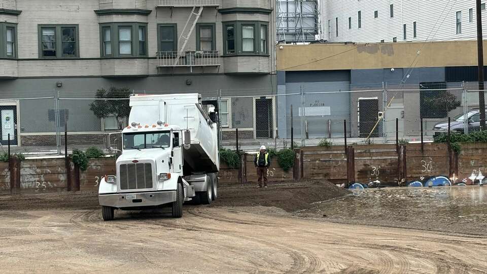 Trucks are dumping dirt to firm up the lot at 360 5th St. in San Francisco’s SoMa neighborhood. The long vacant lot had developed a large, water-filled hole.