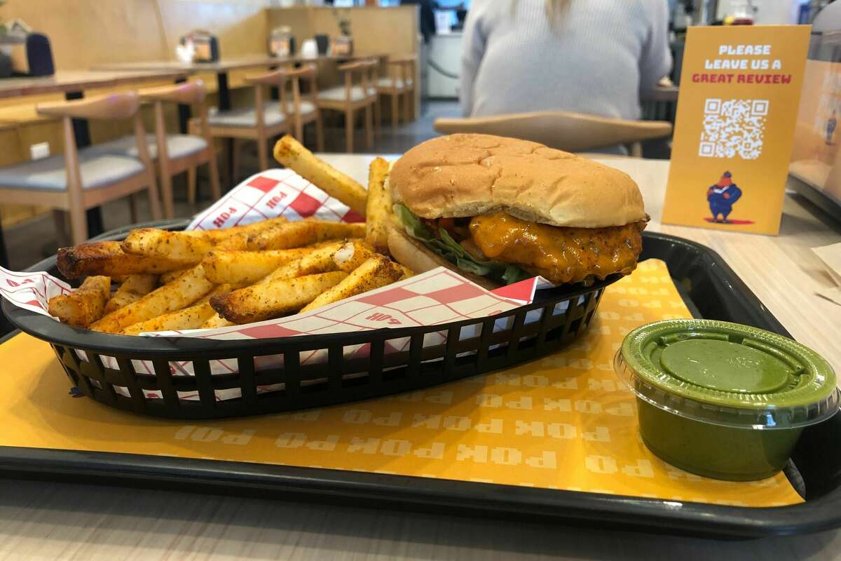 The chicken sandwich combo with 'balle balle fries' and a side of the 'naughty sauce' at Pok Pok Po in Houston's Midtown.