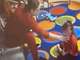 Video footage shows a YMCA caregiver reaching for a toddler's neck.