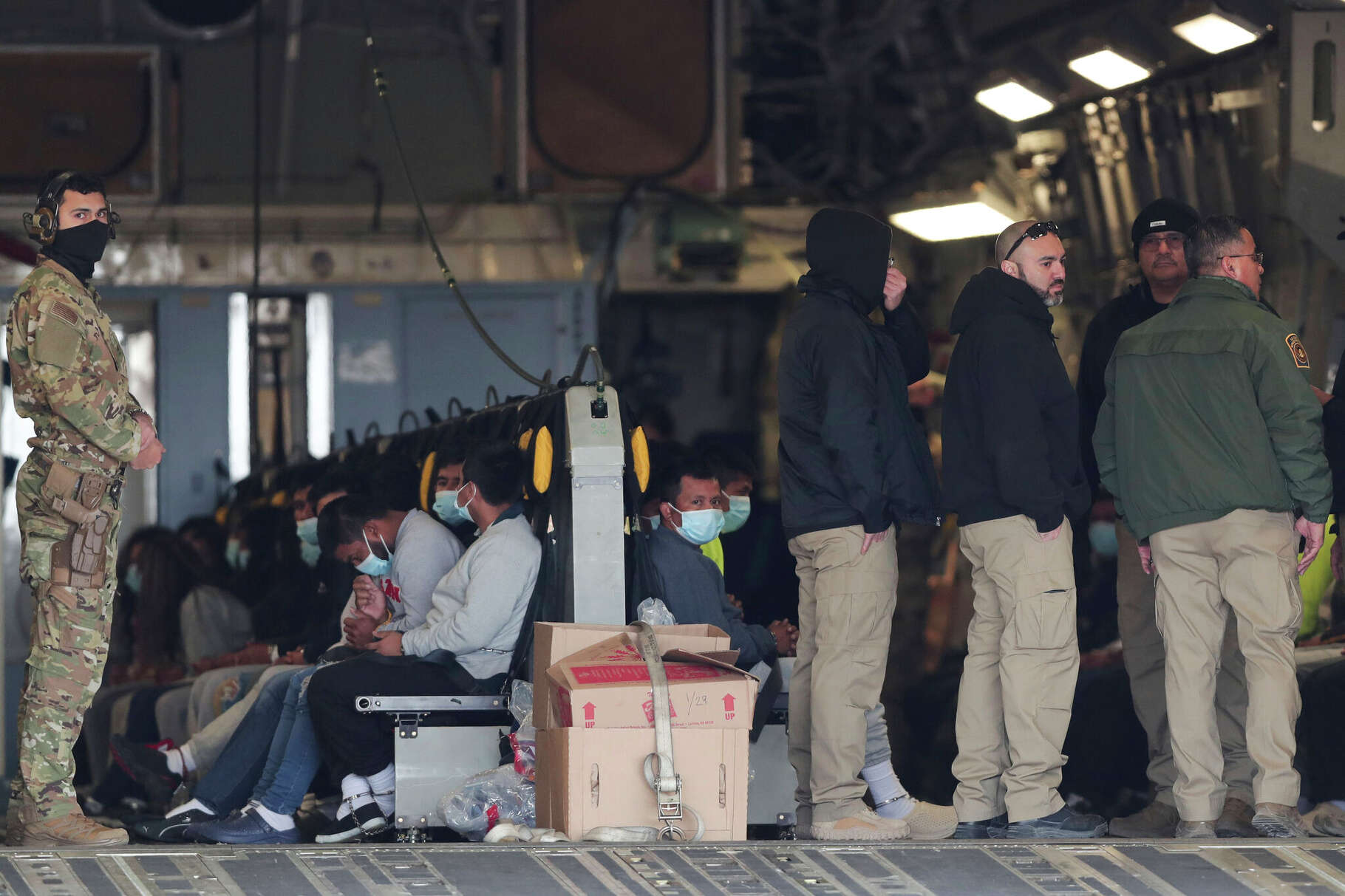 Migrants sit on a military aircraft at Fort Bliss in El Paso, Tx., Thursday, Jan. 30, 2025, awaiting their deportation to Guatemala. (AP Photo/Christian Chavez)