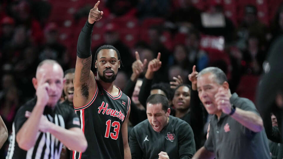 Houston forward J'Wan Roberts (13) points after forcing a turnover during the first half of an NCAA men’s college basketball game, Wednesday, Jan. 22, 2025, in Houston.