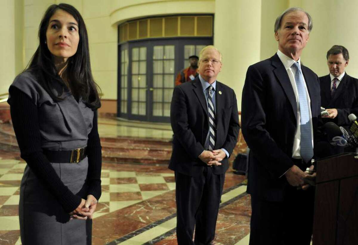 Republican gubernatorial candidate Tom Foley, right, holds a news conference to concede in the governor's race to Democrat Dan Malloy with wife Leslie, left, and running mate Mark Boughton, center, by his side in Hartford, Conn., Mon, Nov. 8, 2010. (AP Photo/Jessica Hill)